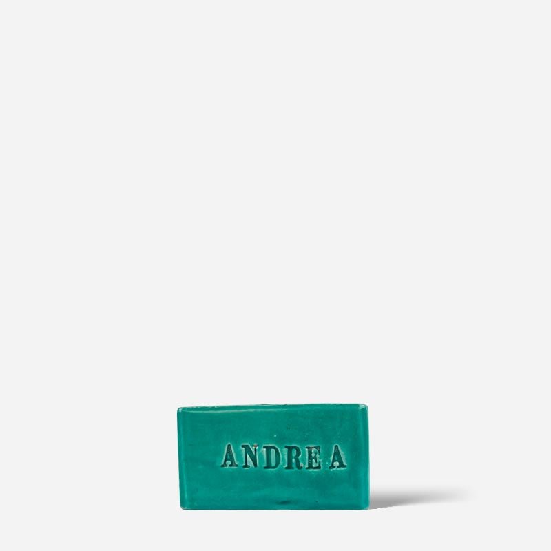 La scultura personalizzata con nome "Carpe Diem" usata come fermacarte su una scrivania.