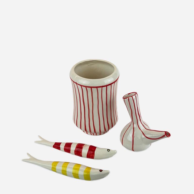 L'Oliera Valenciana accanto a una bottiglia di olio per un confronto delle dimensioni.