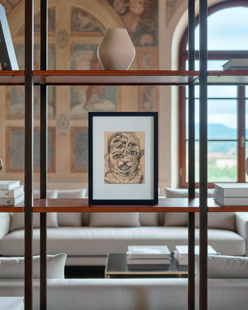 Il quadro Sguardi Inconscio di Massimiliano Precisi, all'interno di una libreria, in un living moderno di design
