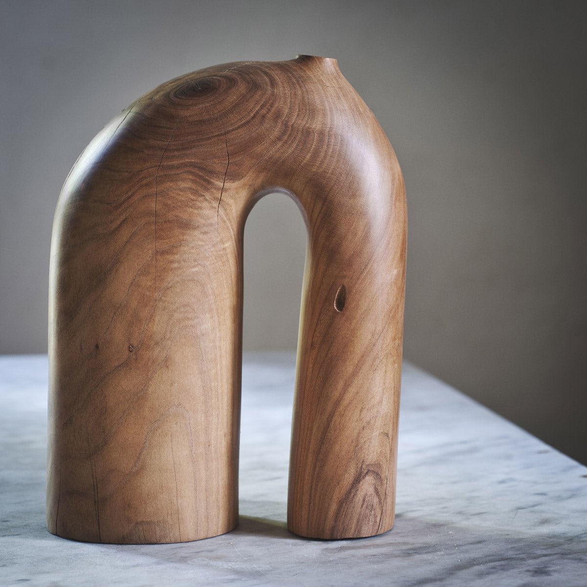 Dettaglio della firma dell'artista Estebanland sulla base della scultura in ciliegio.