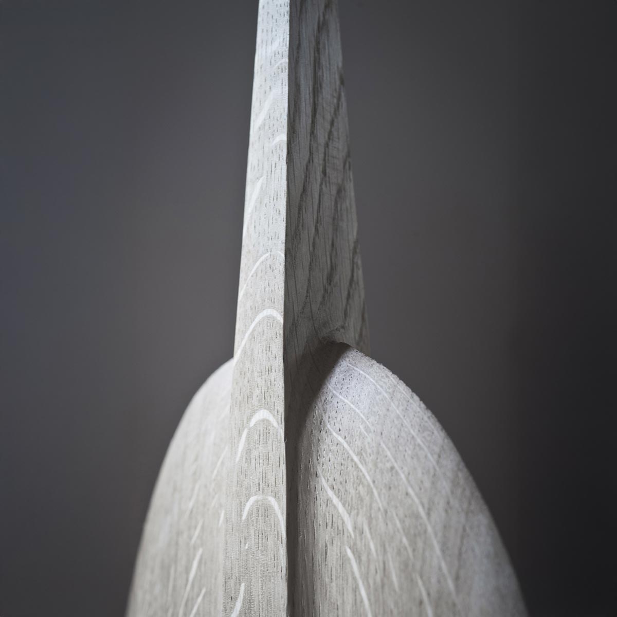 La scultura in legno di rovere esposta da sola su una mensola, mostrando la sua forma a totem.