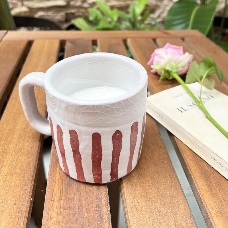 La Coppia tazze Blu e rubino accanto a una caffettiera per mostrare le dimensioni.