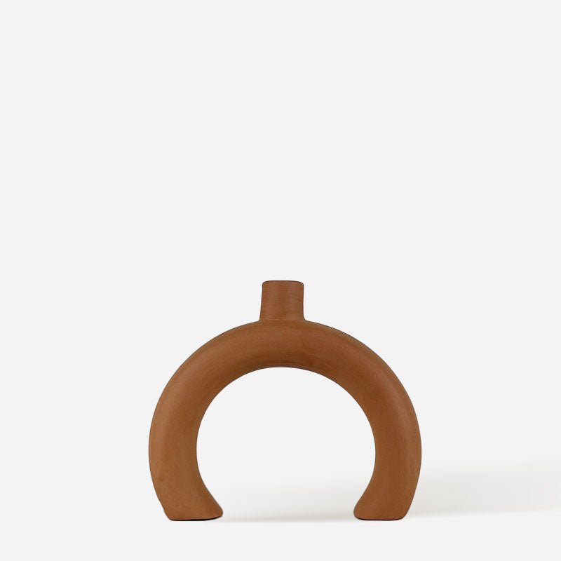 La coppia di Candelabri Archi Mediterráneos sulla mensola di un camino in un ambiente rustico.