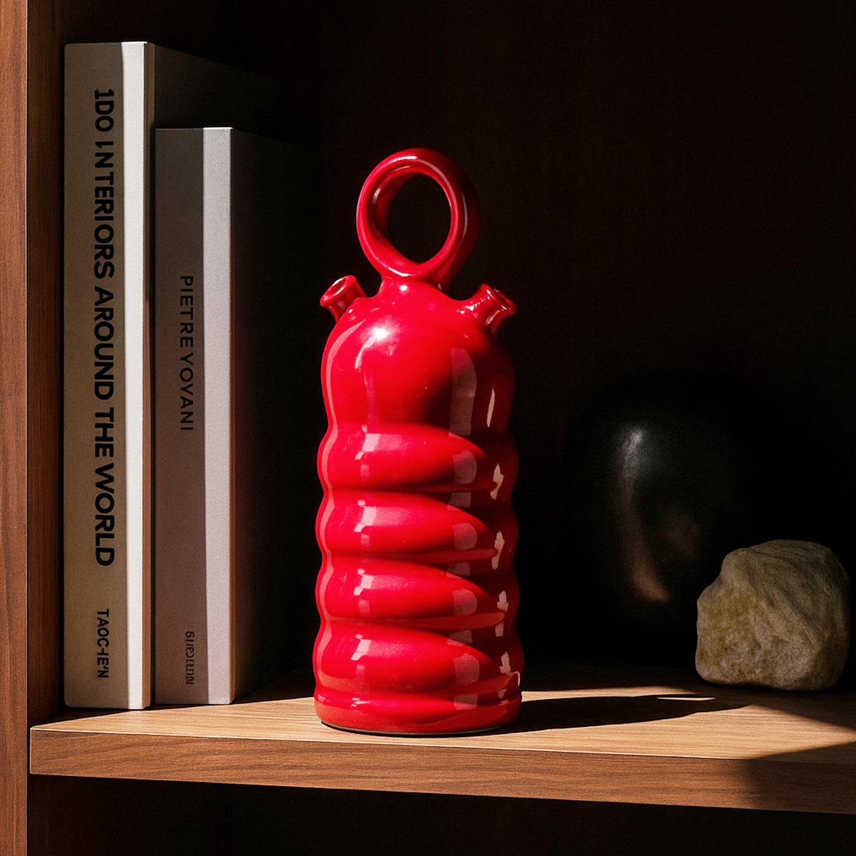 Primo piano della finitura smaltata rosso brillante e dei riflessi di luce sul Botijo Rojo.