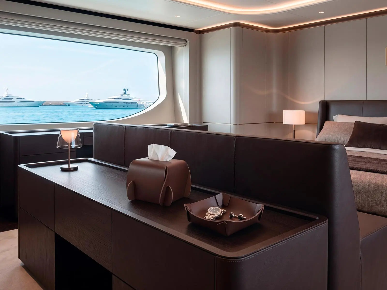 Porta veline e svuotatasche GESTO in cuoio su una console nella cabina di uno yacht contemporaneo.