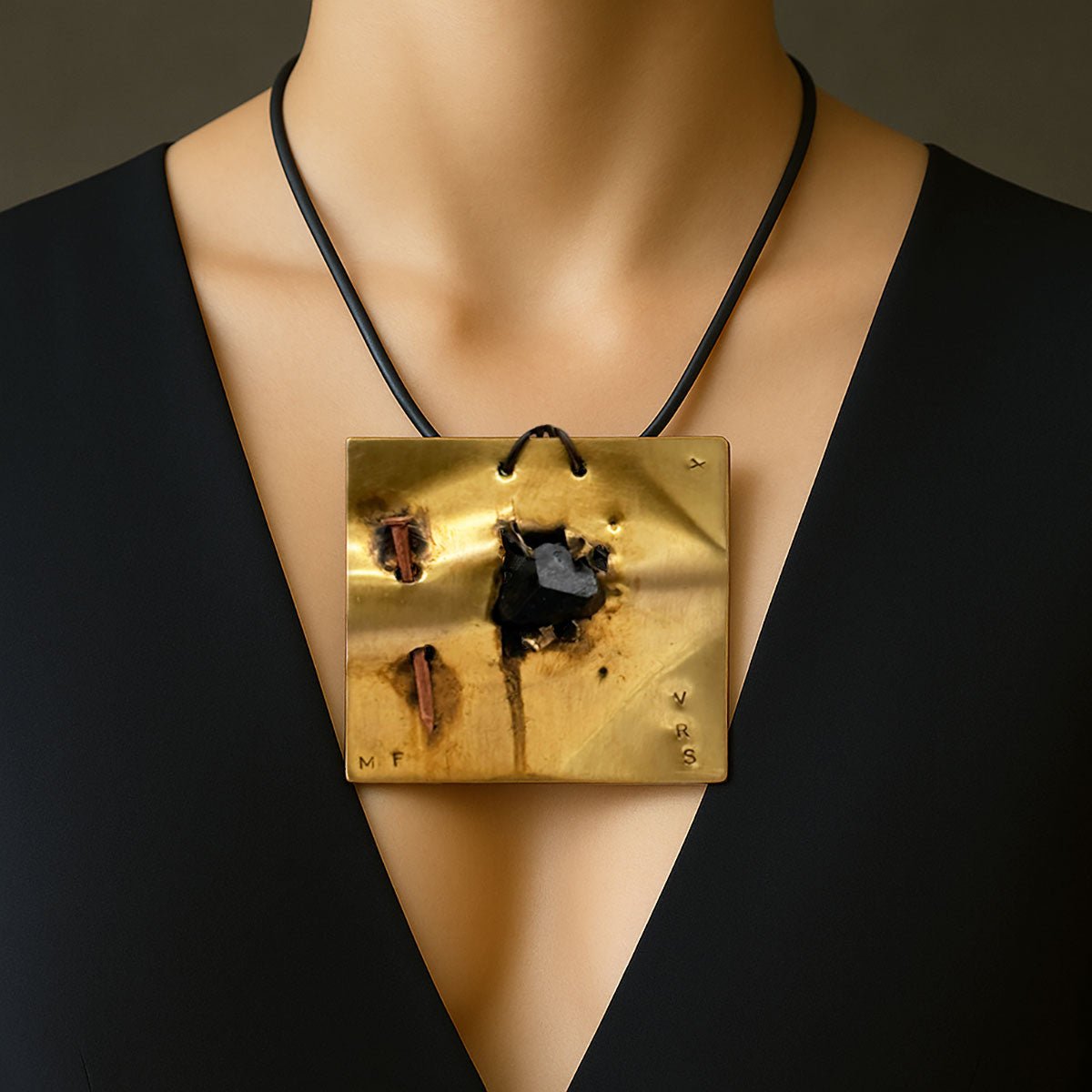 Monile Ombra Fratturata, gioiello artigianale con placca in ottone, pietra nera e chiodo.