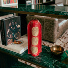 Retro della scultura Vicode con colature materiche di smalto rosso e bruno.