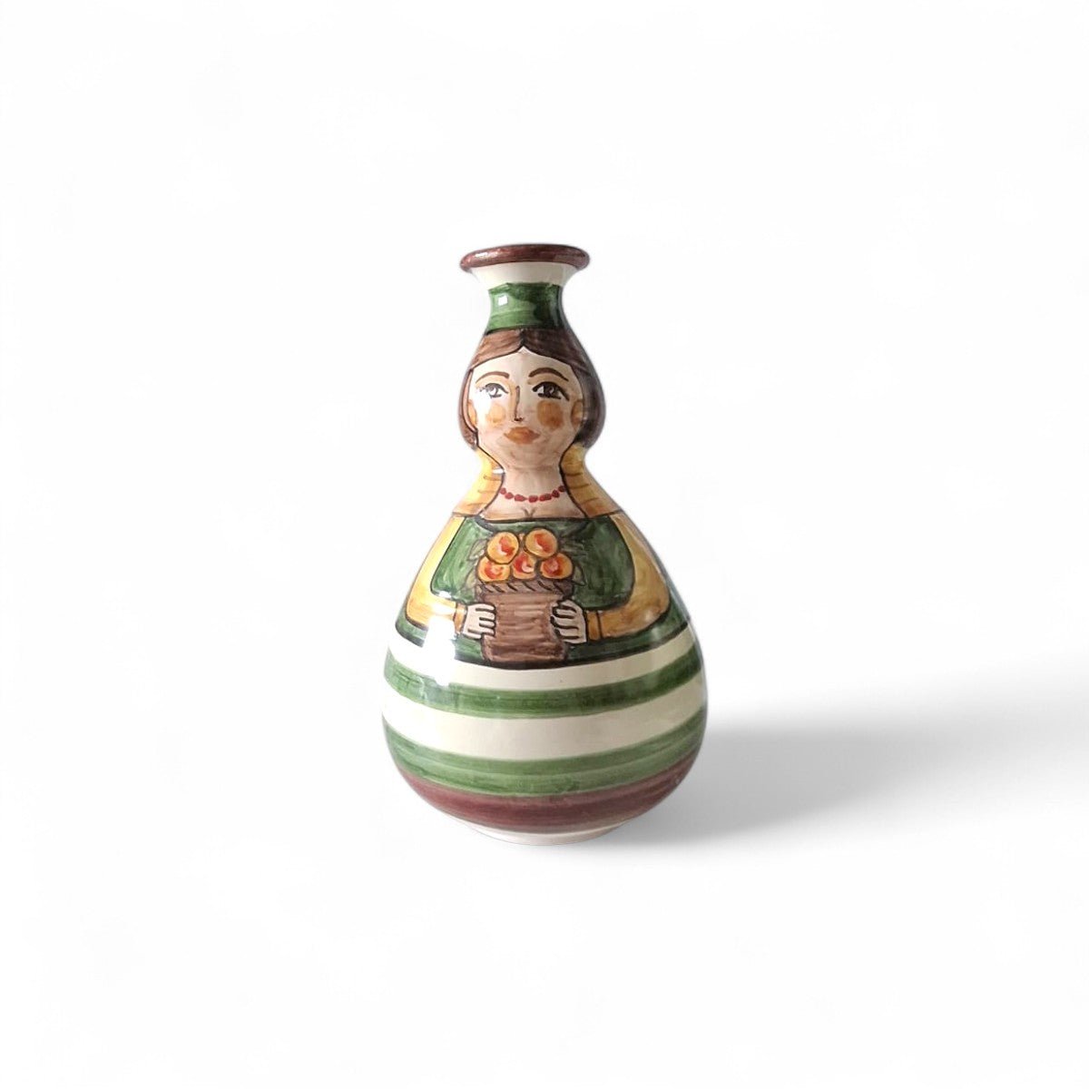 Primo piano del volto gentile e sorridente della Pupetta Fiorita in maiolica.