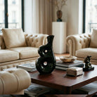 Vaso scultoreo nero lucido con doppi fori passanti asimmetrici